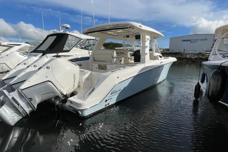 Slide: The Image of Boats docked in a marina, featuring a 2022 Boston Whaler 350 Realm. - 3