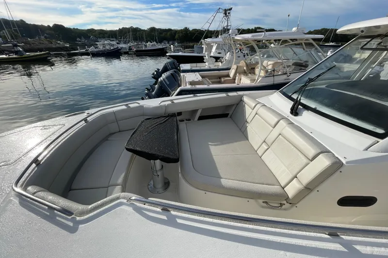 Slide: The Image of 2022 Boston Whaler 350 Realm boat with spacious seating in a marina setting. - 30