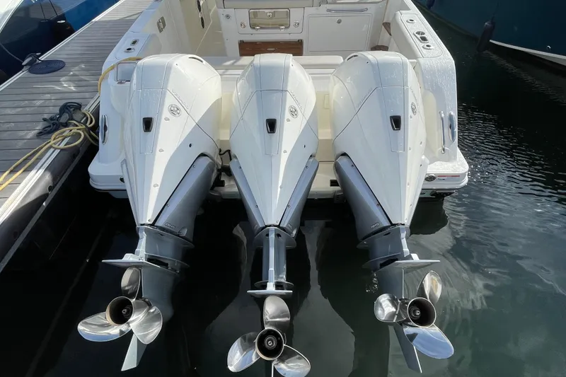 Slide: The Image of Triple outboard engines on a 2022 Boston Whaler 350 Realm boat at dock. - 33