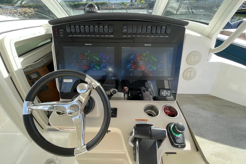 Slide: The Image of 2022 Boston Whaler 350 Realm helm with dual displays and modern controls. - 5