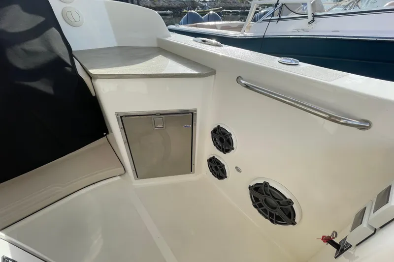 Slide: The Image of Interior of 2022 Boston Whaler 350 Realm boat with speakers and storage compartment. - 9