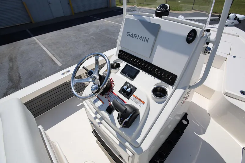 Slide: The Image of 2024 Pathfinder 2300 HPS boat console with Garmin navigation system and steering wheel. - 19