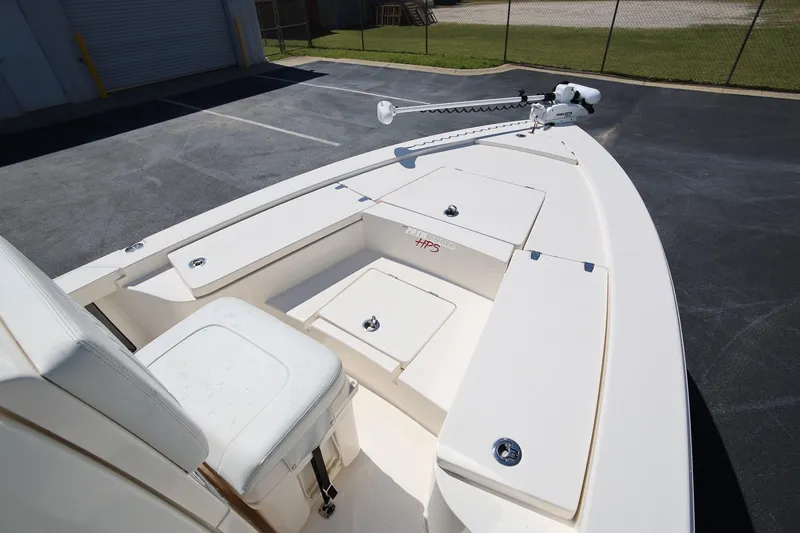 Slide: The Image of 2024 Pathfinder 2300 HPS boat deck with storage compartments and trolling motor. - 21