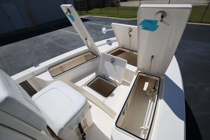 Slide: The Image of 2024 Pathfinder 2300 HPS boat with open storage compartments on deck. - 22