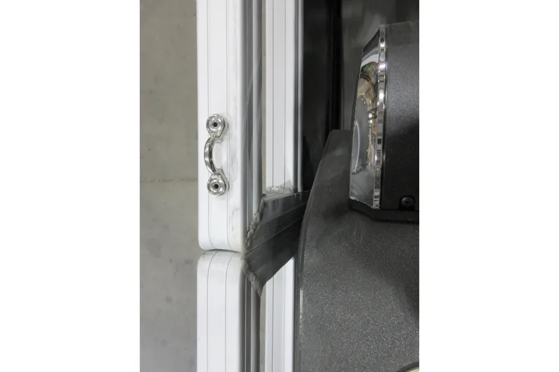 Slide: The Image of Close-up of Sun Tracker SportFish 22 DLX 2026 boat handle and light detail. - 12