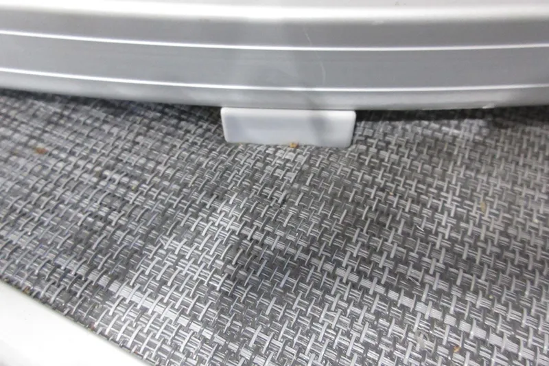 Slide: The Image of Close-up of 2026 Sun Tracker SportFish 22 DLX boat flooring and railing detail. - 16