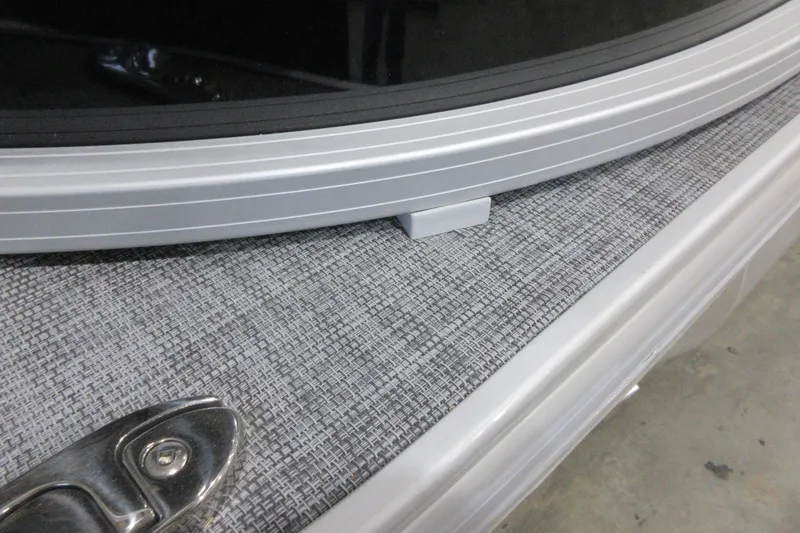 Slide: The Image of 2026 Sun Tracker SportFish 22 DLX boat detail, featuring sleek metal and textured flooring. - 18