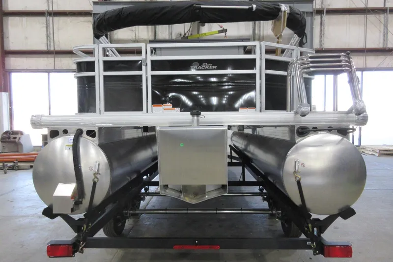 Slide: The Image of 2026 Sun Tracker SportFish 22 DLX pontoon boat in a warehouse setting. - 3