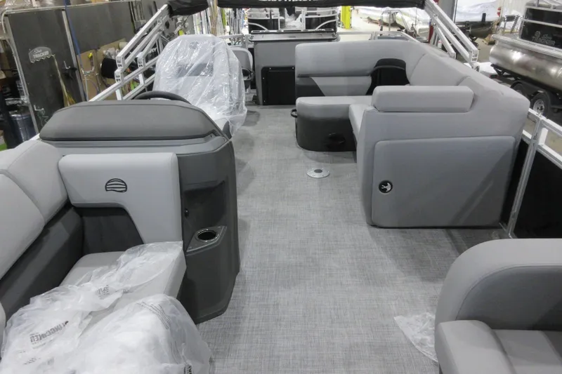 Slide: The Image of 2026 Sun Tracker SportFish 22 DLX pontoon boat interior with gray seating and modern design. - 4