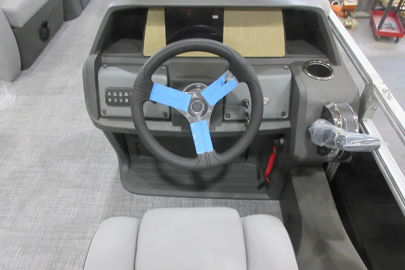 Slide: The Image of 2026 Sun Tracker SportFish 22 DLX boat dashboard with steering wheel and controls. - 6