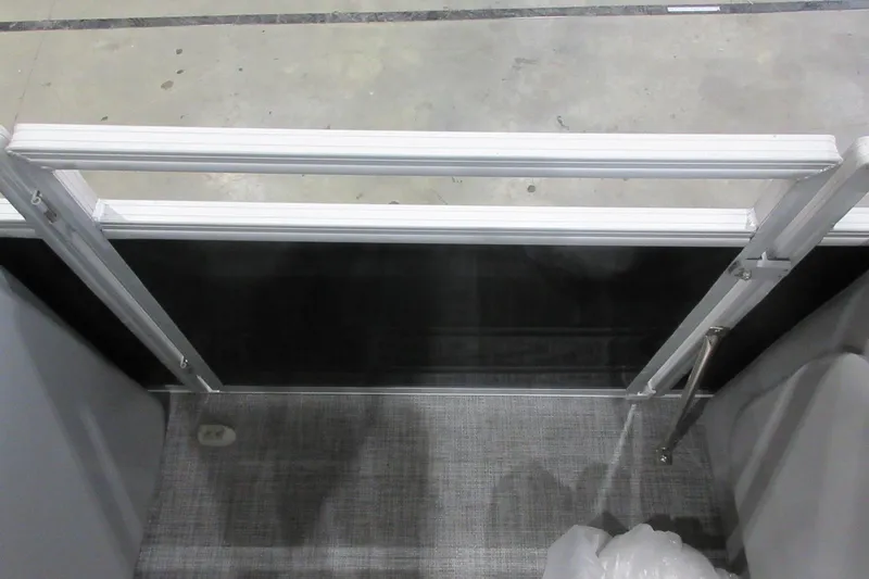 Slide: The Image of Sun Tracker SportFish 22 DLX 2026 boat interior gate with gray flooring. - 7