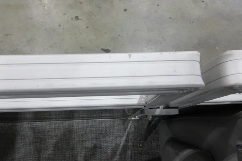 Slide: The Image of Close-up of Sun Tracker SportFish 22 DLX boat railing, 2026 model, on concrete floor. - 8