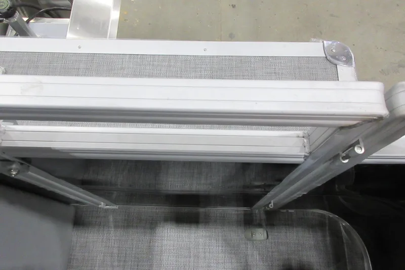 Slide: The Image of 2026 Sun Tracker SportFish 22 DLX boat interior with aluminum railing and textured flooring. - 9