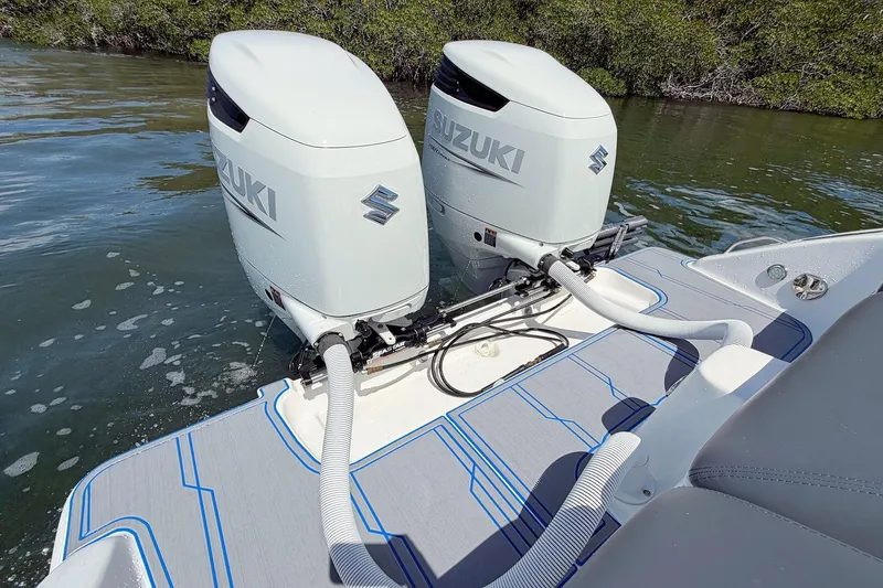 Slide: The Image of 2003 Marlago FS 35 Center Console with dual Suzuki outboard motors on water. - 10