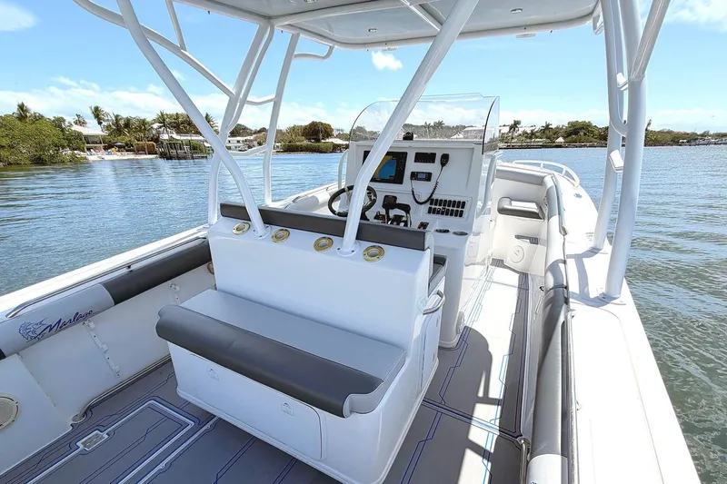 Slide: The Image of 2003 Marlago FS 35 Center Console boat interior with helm, seating, and water view. - 11