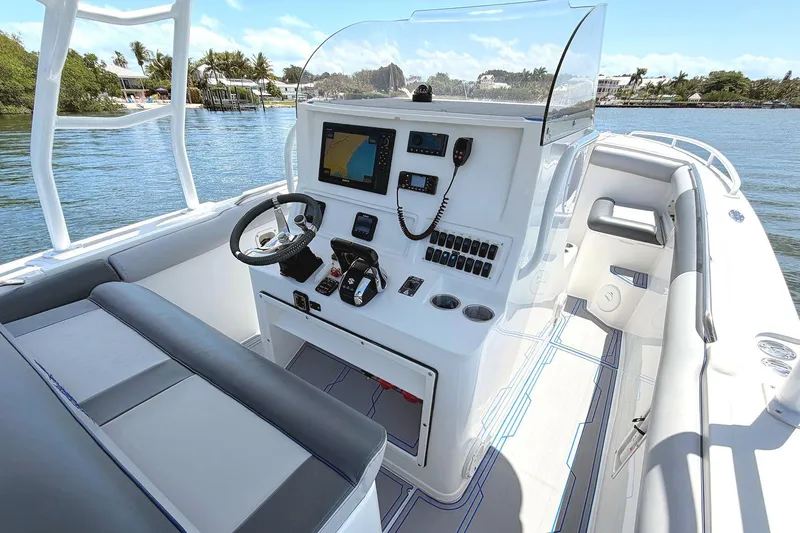 Slide: The Image of 2003 Marlago FS 35 Center Console boat interior with navigation equipment and seating. - 12