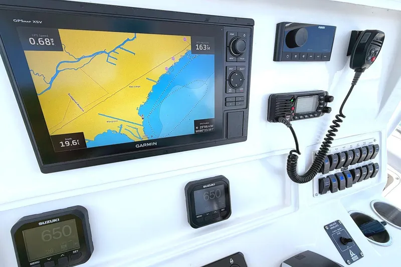 Slide: The Image of 2003 Marlago FS 35 Center Console dashboard with Garmin GPS and marine electronics. - 13