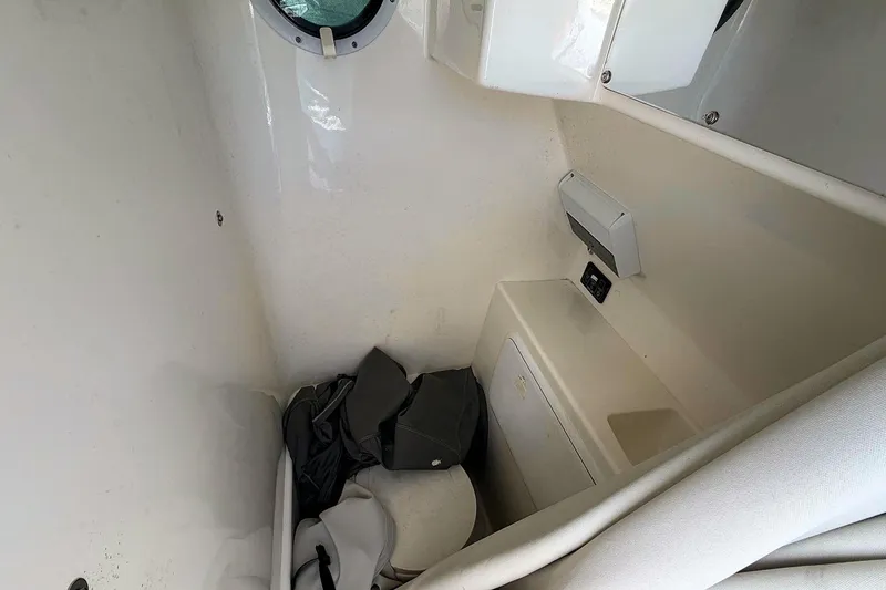 Slide: The Image of Interior cabin of 2003 Marlago FS 35 Center Console boat, featuring storage and seating. - 17
