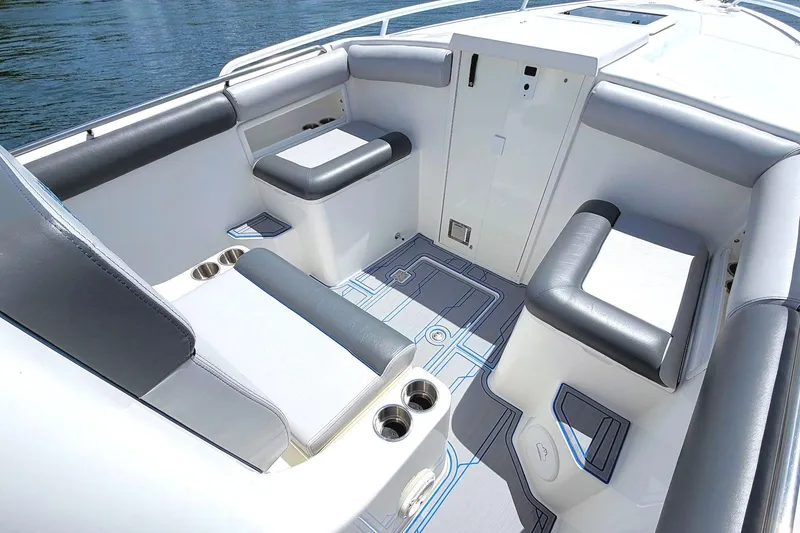 Slide: The Image of 2003 Marlago FS 35 Center Console boat interior with cushioned seating and cup holders. - 18