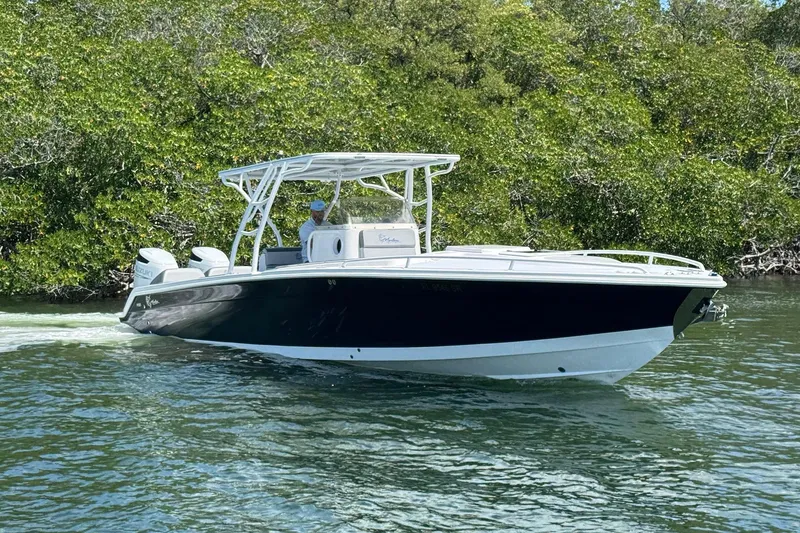 Slide: The Image of 2003 Marlago FS 35 Center Console boat cruising on a calm waterway. - 3