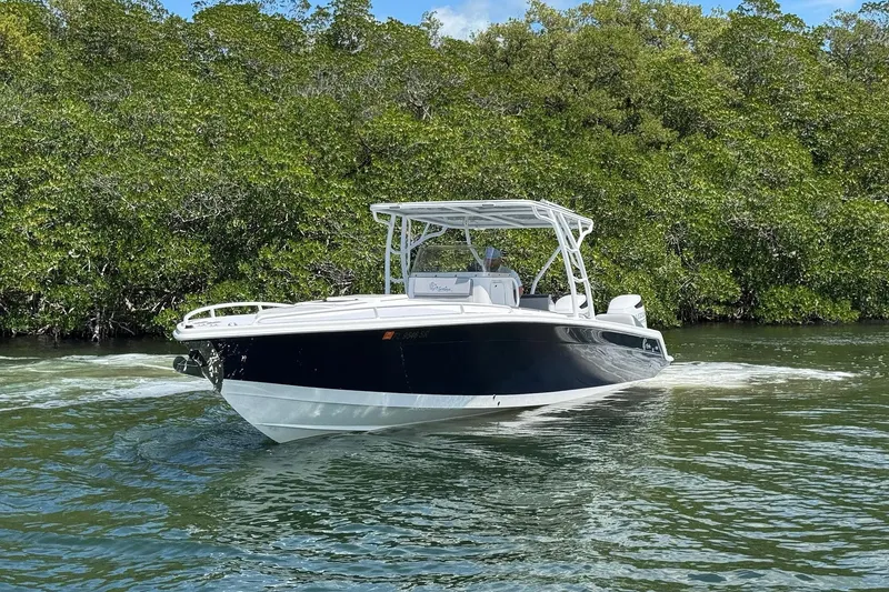 Slide: The Image of 2003 Marlago FS 35 Center Console boat cruising on a calm waterway. - 5