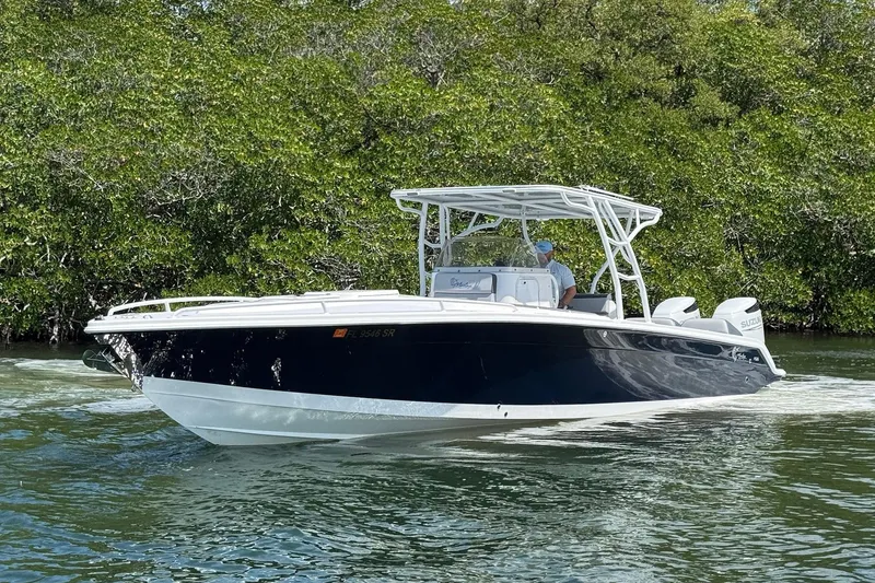 Slide: The Image of 2003 Marlago FS 35 Center Console boat cruising on a calm waterway. - 6