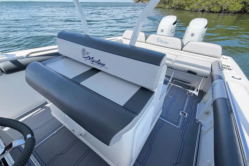 Slide: The Image of 2003 Marlago FS 35 Center Console boat interior with seating and dual engines. - 8