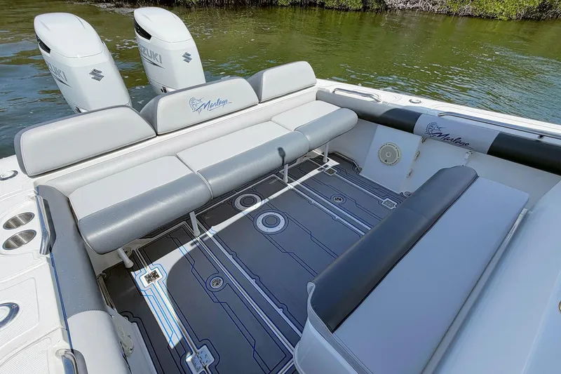 Slide: The Image of 2003 Marlago FS 35 Center Console boat interior with seating and dual Suzuki engines. - 9