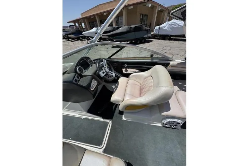Slide: The Image of Interior of a 2011 MasterCraft X-45 boat with beige seating and dashboard controls. - 3