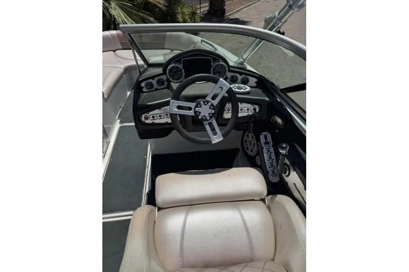 Slide: The Image of 2011 MasterCraft X-45 boat cockpit with steering wheel and dashboard controls. - 4