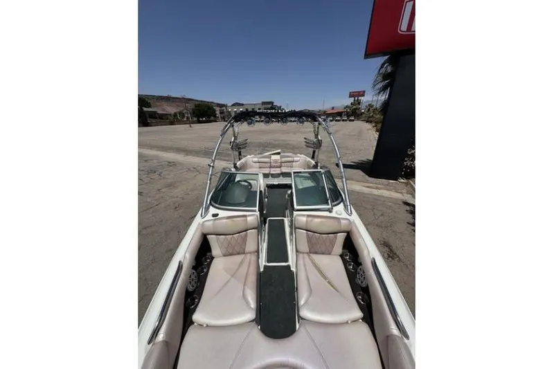 Slide: The Image of 2011 MasterCraft X-45 boat interior with seating and wakeboard tower, parked outdoors. - 5