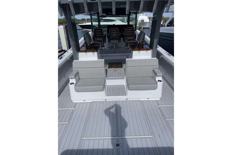 Slide: The Image of 2025 HCB 56 Suenos boat interior with seating and helm, docked at marina. - 9