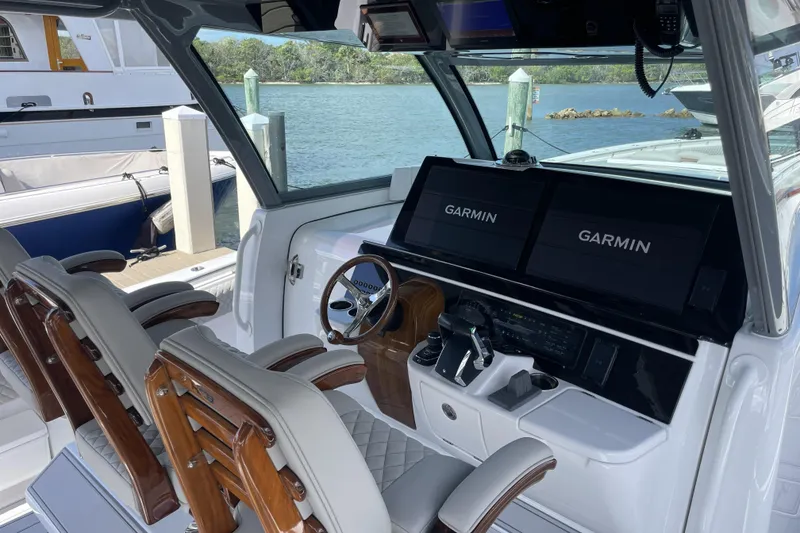 Slide: The Image of Helm of 2025 HCB 56 Suenos with Garmin displays and luxurious seating. - 14
