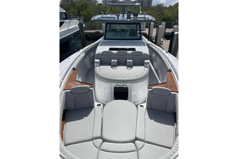 Slide: The Image of 2025 HCB 56 Suenos luxury boat with spacious seating and sleek design at dock. - 20
