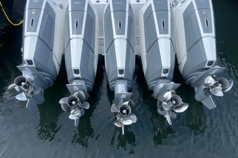 Slide: The Image of Four powerful outboard motors on a 2025 HCB 56 Suenos boat, viewed from above. - 7