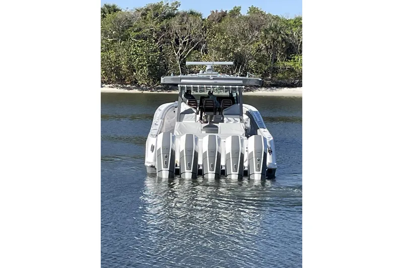 Slide: The Image of 2025 HCB 56 Suenos boat with multiple engines on calm water. - 6