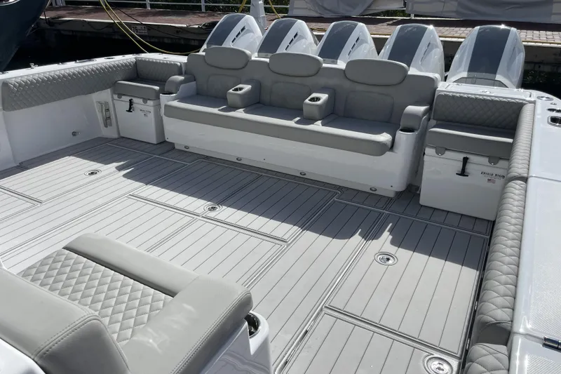 Slide: The Image of 2025 HCB 56 Suenos boat interior with gray seating and multiple outboard engines. - 8