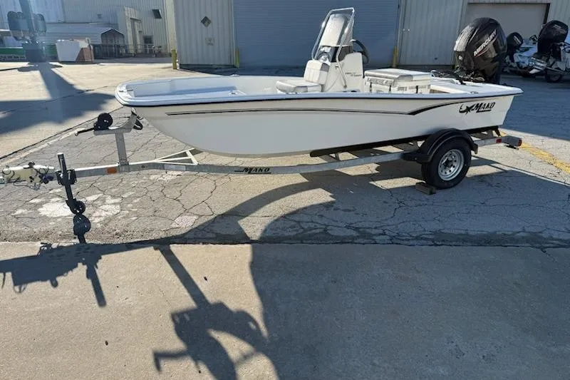 The Image of 2025 Mako Pro Skiff 15 CC boat on trailer in industrial setting. - 0