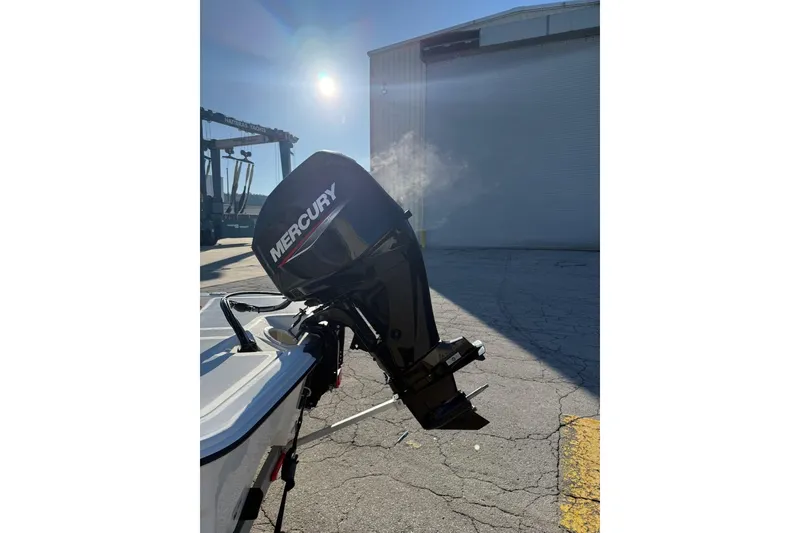 Slide: The Image of 2025 Mako Pro Skiff 15 CC with Mercury outboard motor in sunlight. - 12