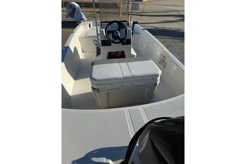 Slide: The Image of 2025 Mako Pro Skiff 15 CC boat interior with steering console and seating. - 3