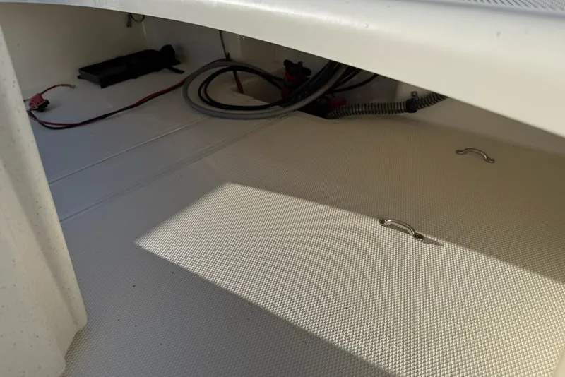 Slide: The Image of Storage compartment of 2025 Mako Pro Skiff 15 CC boat, showing interior details. - 4