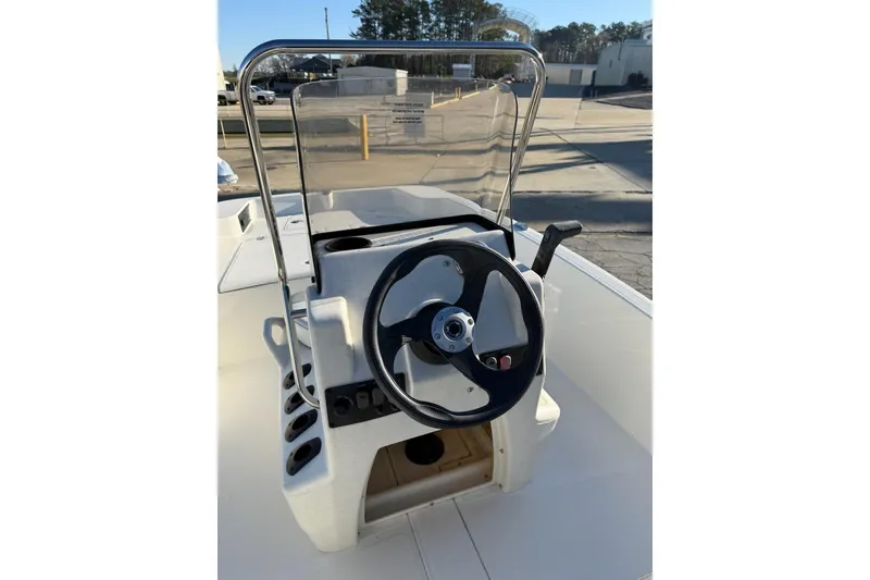 Slide: The Image of 2025 Mako Pro Skiff 15 CC boat console with steering wheel and controls. - 6