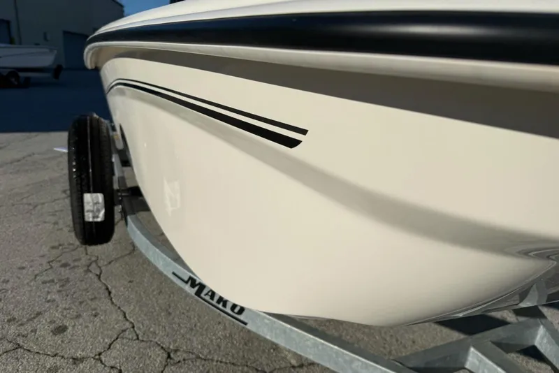 Slide: The Image of 2025 Mako Pro Skiff 15 CC boat on trailer, close-up view of hull design. - 7