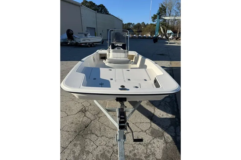 Slide: The Image of 2025 Mako Pro Skiff 15 CC boat on trailer, parked outdoors. - 8