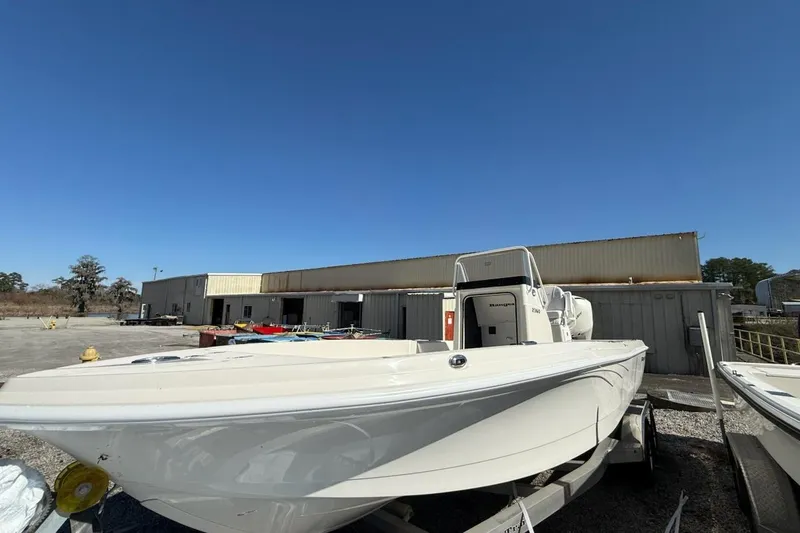 The Image of 2025 Ranger 2360 Bay boat on trailer in industrial yard. - 0