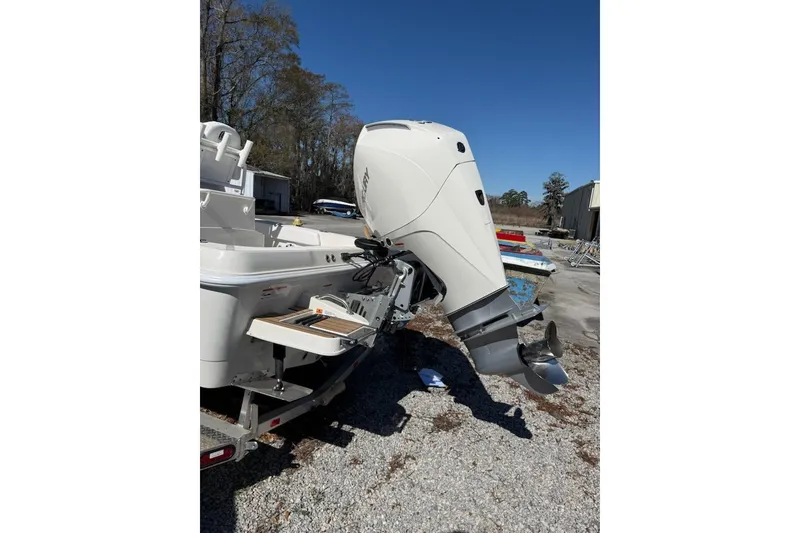 Slide: The Image of 2025 Ranger 2360 Bay boat with outboard motor on a trailer. - 13