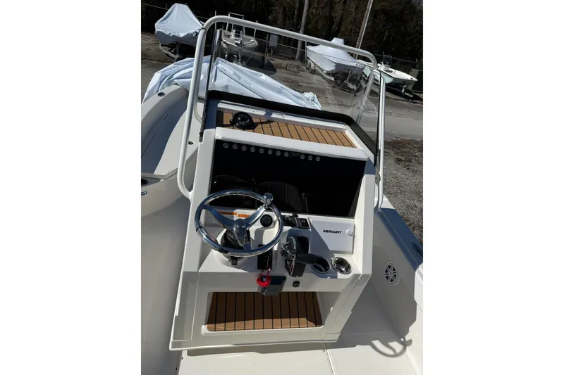Slide: The Image of 2025 Ranger 2360 Bay boat console with steering wheel and controls. - 5