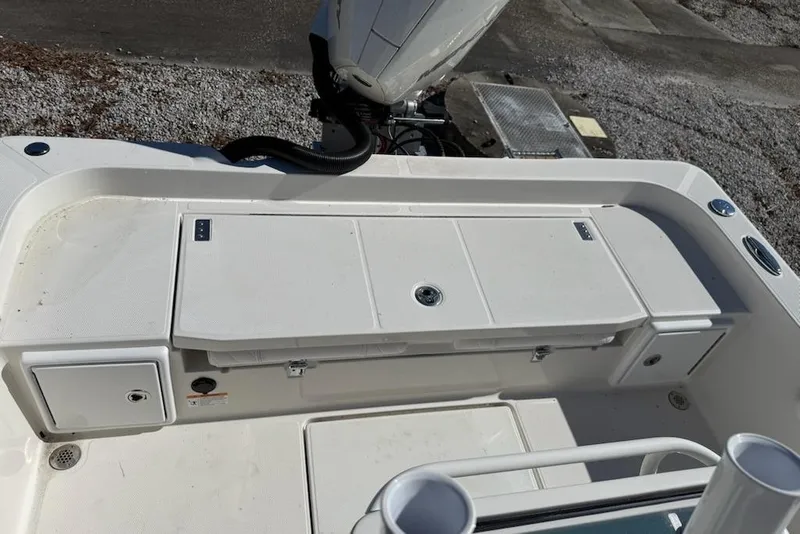 Slide: The Image of 2025 Ranger 2360 Bay boat deck with storage compartments and motor. - 8