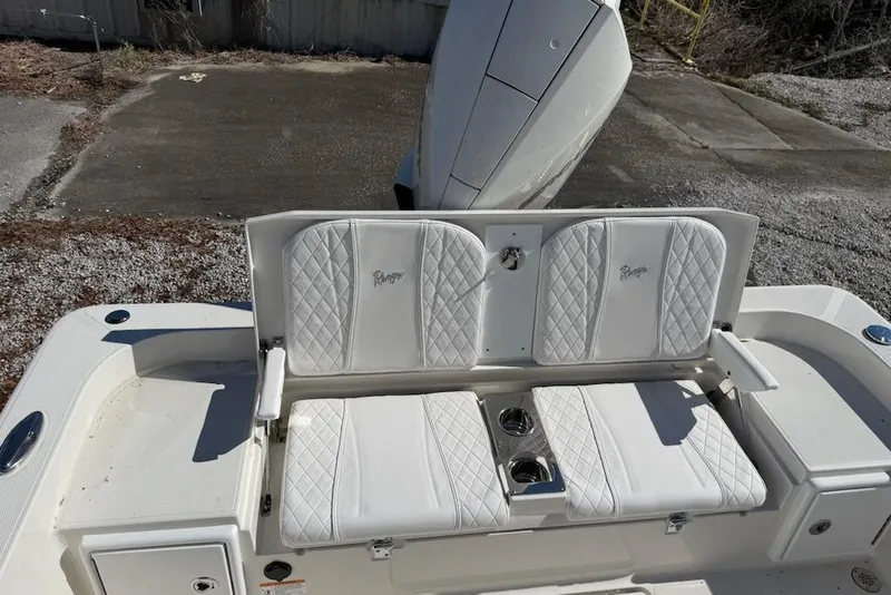 Slide: The Image of 2025 Ranger 2360 Bay boat with white quilted seating and cup holders. - 9