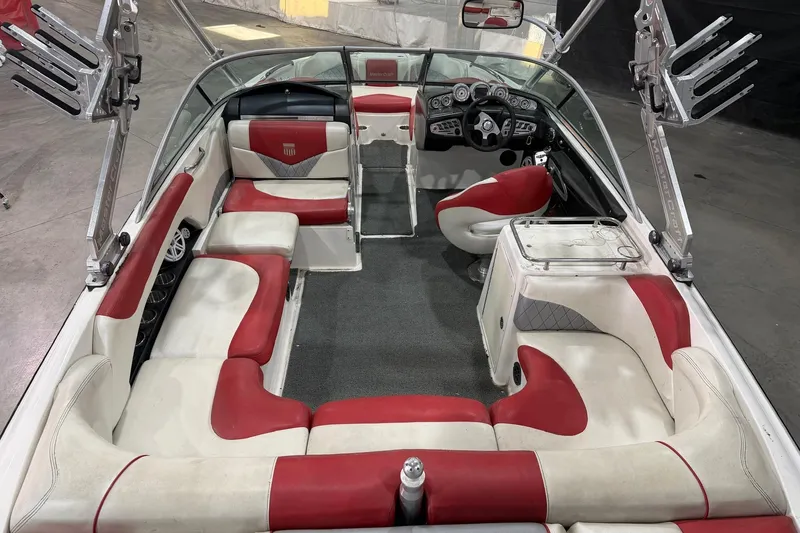 Slide: The Image of 2008 MasterCraft X-35 boat interior with red and white seating, sleek design, and modern dashboard. - 5